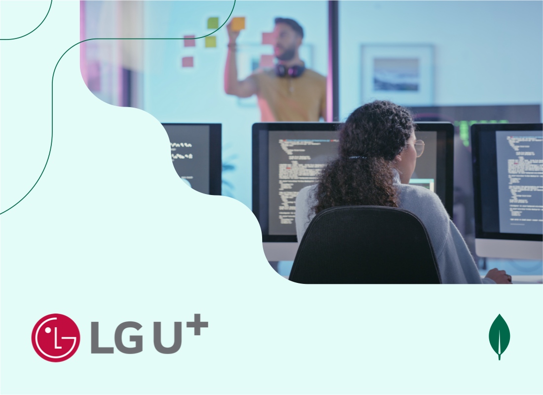 A person working on a desktop computer with code displayed on the screen.